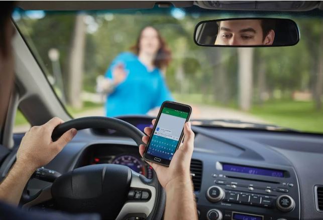 a driver holding a phone